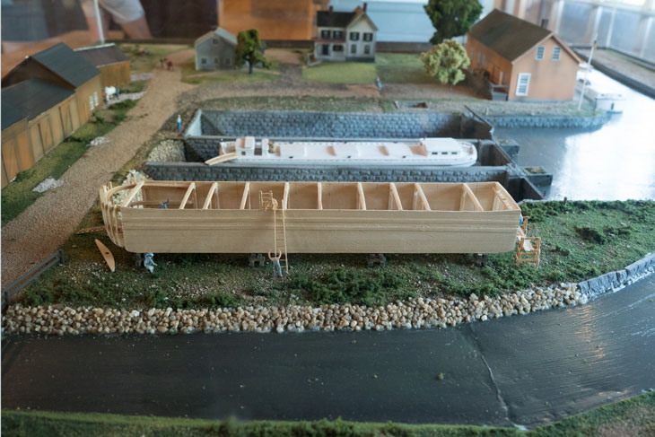 Boat with drydock diorama by Erie Canal in New York